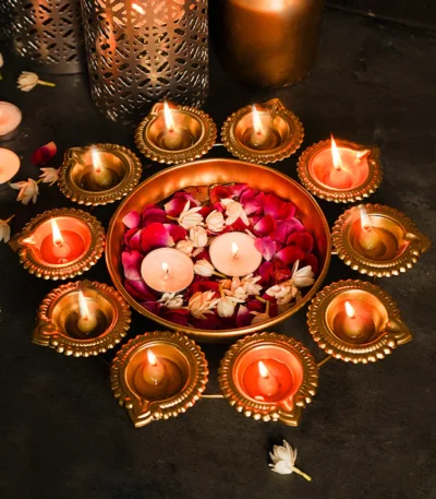 "Stylish metal urli set with classic brass diyas, adding a touch of elegance to any festive or decorative setting."