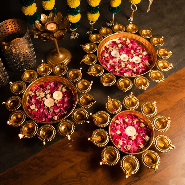 "Stylish metal urli set with classic brass diyas, adding a touch of elegance to any festive or decorative setting."